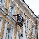 construction-worker-platform-lift-cleaning-restoring-facade-building-image-captures-urban-maintenance-safety-renovation-city-environment_727634-1452
